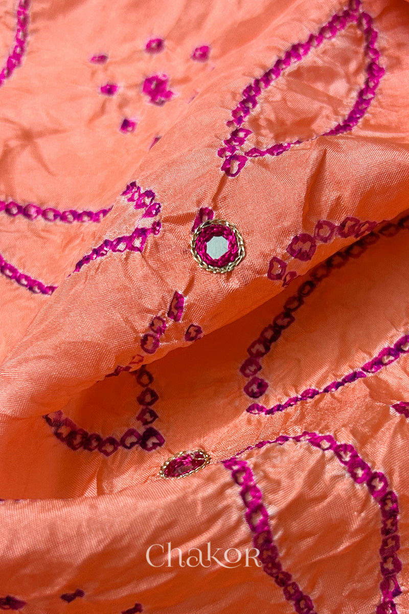 Close-up of Coral pink mulberry silk Bandhani (Rai Bandhej) fabric with rani pink tie-dye motifs, zari embroidered pink mirror work and sequin detailing – CHAKOR.
