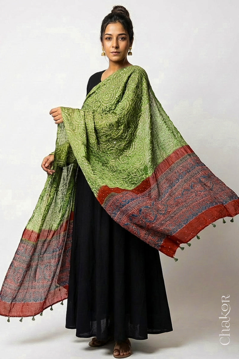 Model wearing leaf green Bandhani gaji silk dupatta with Ajrakh border and brick red pallu.
