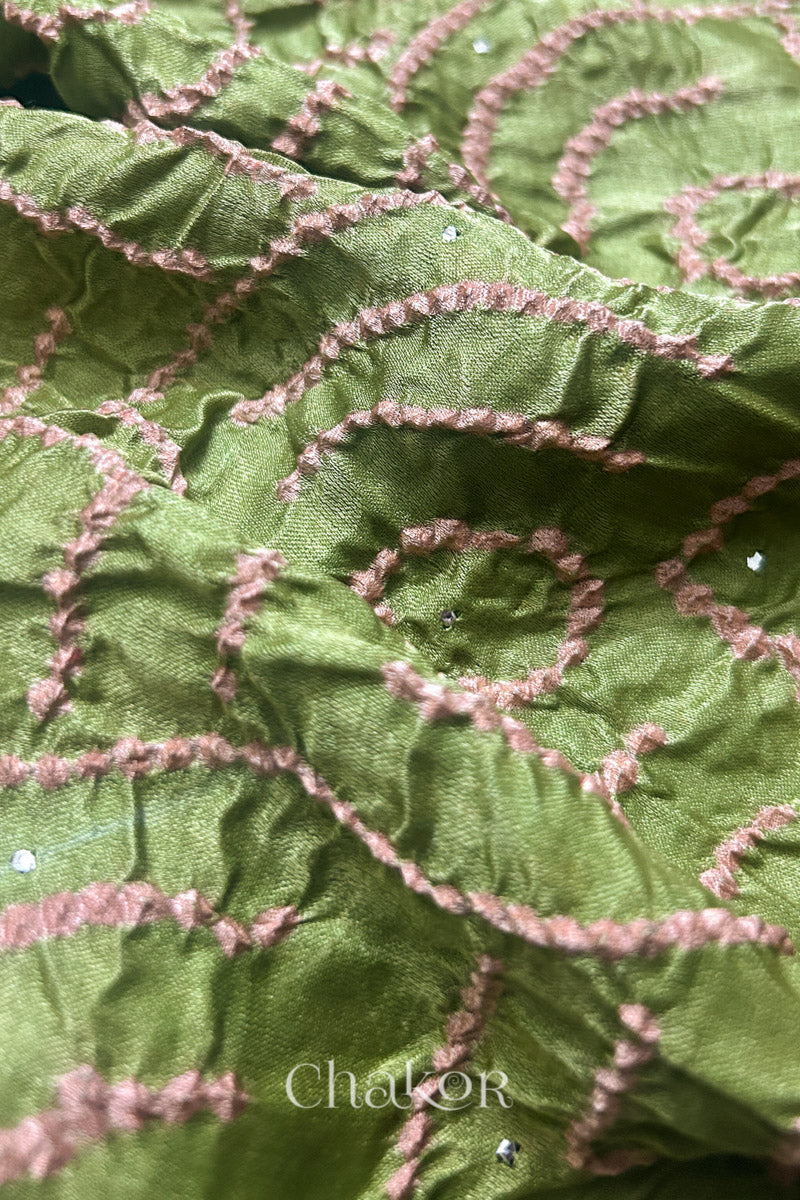 Close-up of leaf green Bandhani tie-dye pattern on gaji silk dupatta fabric.