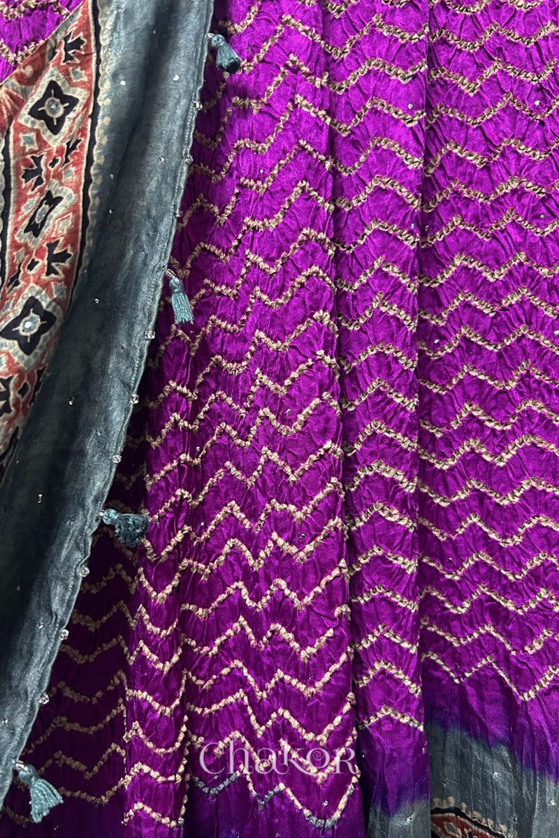 Close-up of magenta Bandhani gaji silk dupatta showing Ajrakh pallu alongside body pattern.