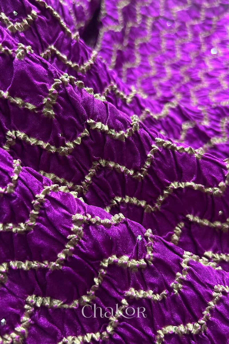 Detail view of magenta Bandhani tie-dye pattern on gaji silk dupatta with metallic embellishment.