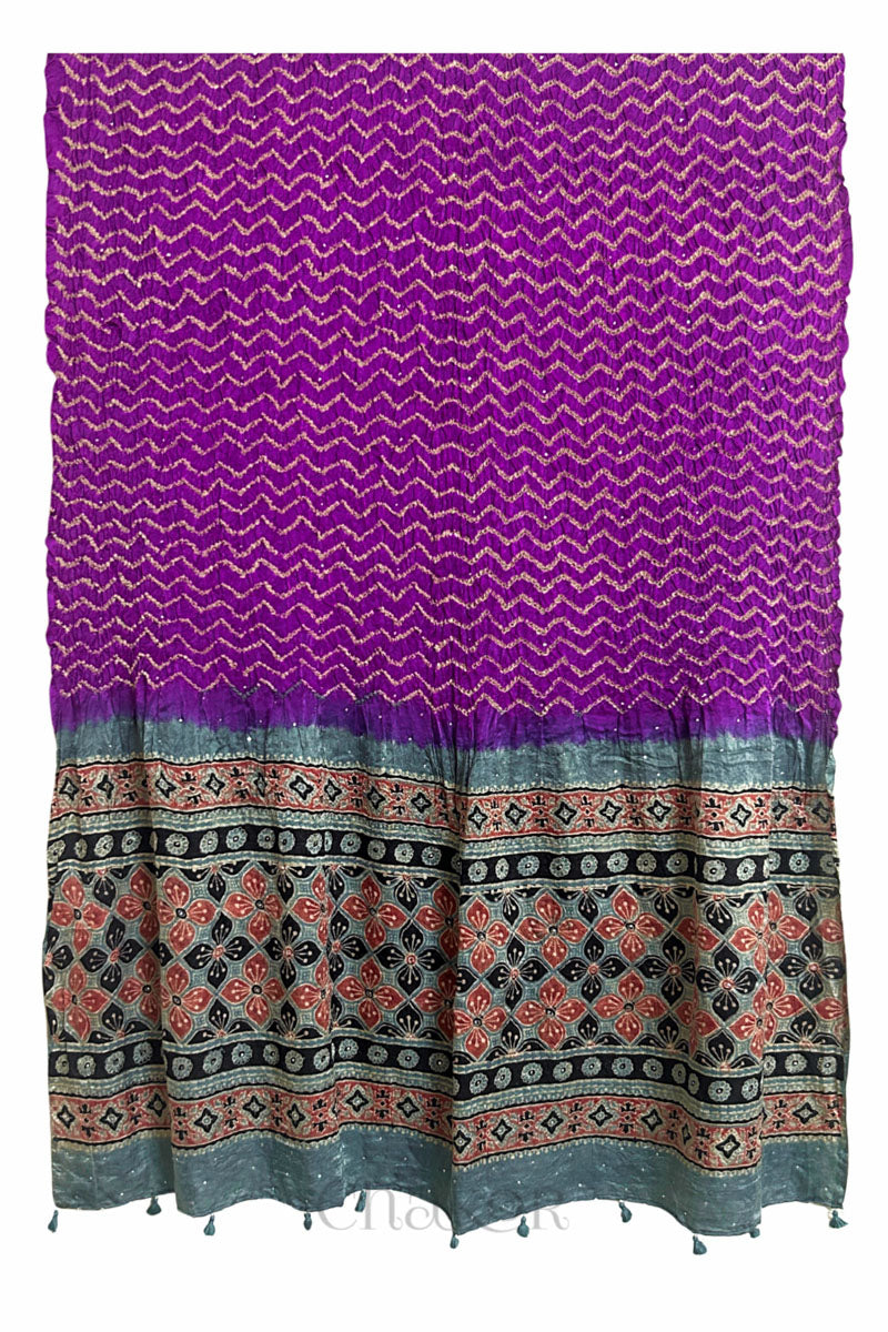 Full-length flat view of magenta Bandhani gaji silk dupatta with Ajrakh border and tasselled edge.
