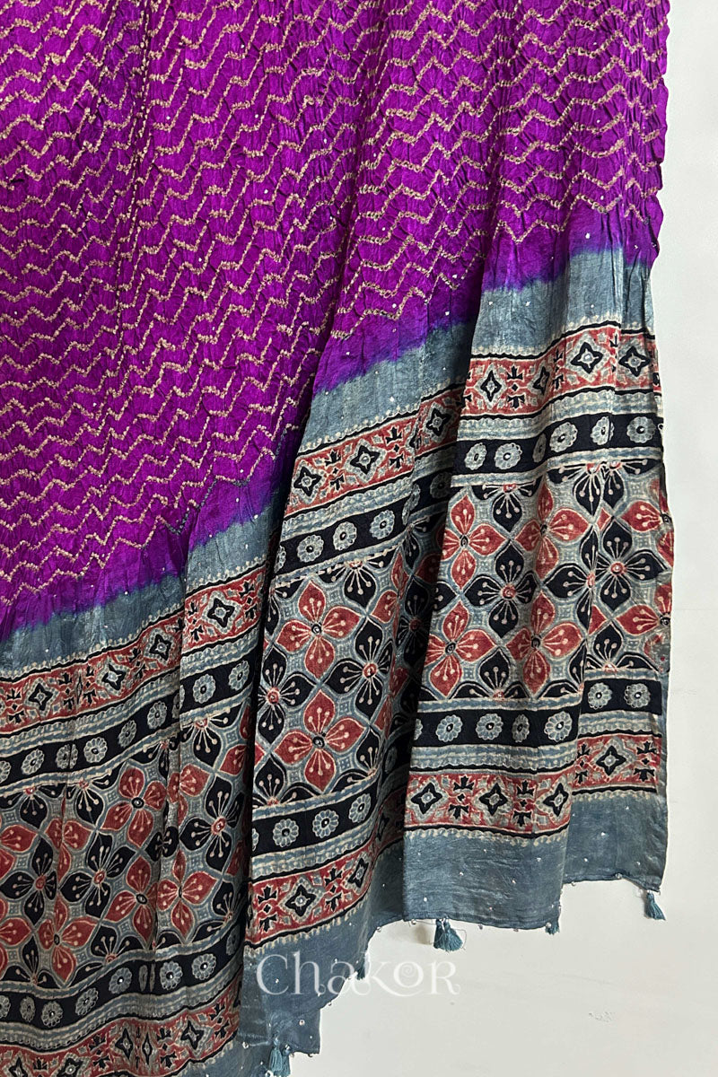 Hanging view of magenta Bandhani gaji silk dupatta highlighting Ajrakh pallu and border.