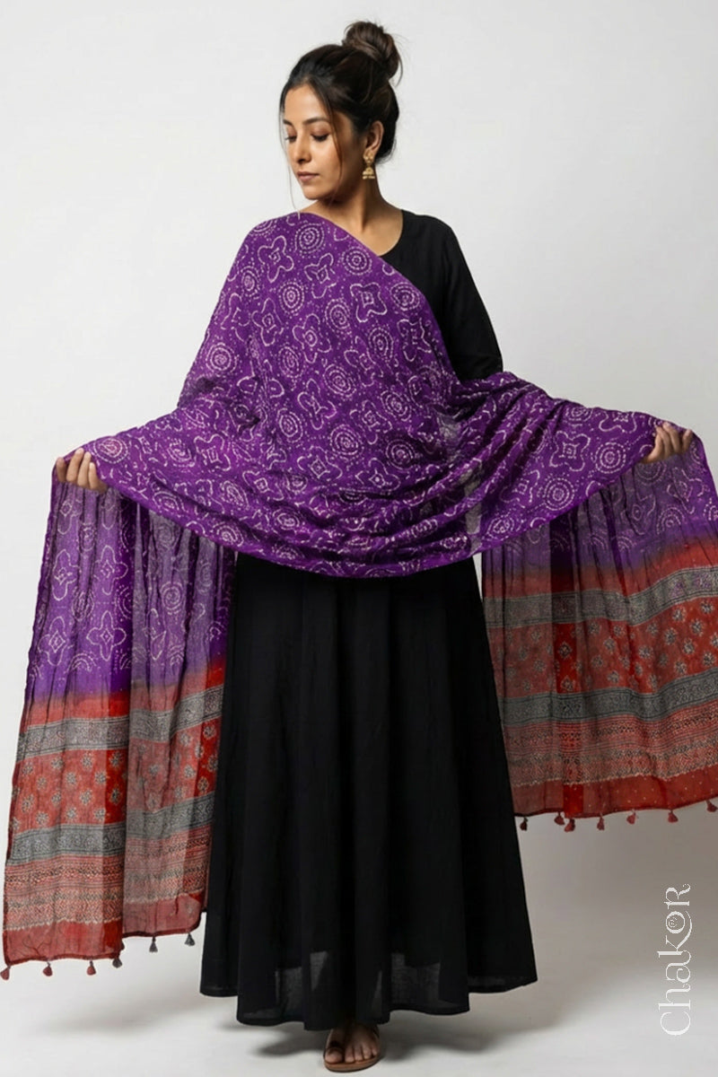 Model wearing purple Bandhani gaji silk dupatta with madder red Ajrakh pallu edged with tassels.