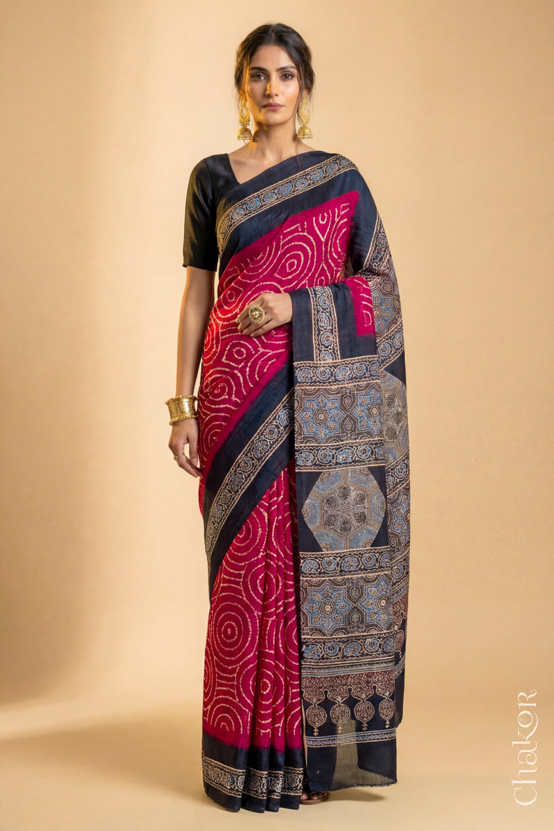 Woman wearing Red Bandhani Saree with Black Ajrakh printed border and pallu in pure gaji silk with traditional bandhej tie-dye, handcrafted in Kutch. 