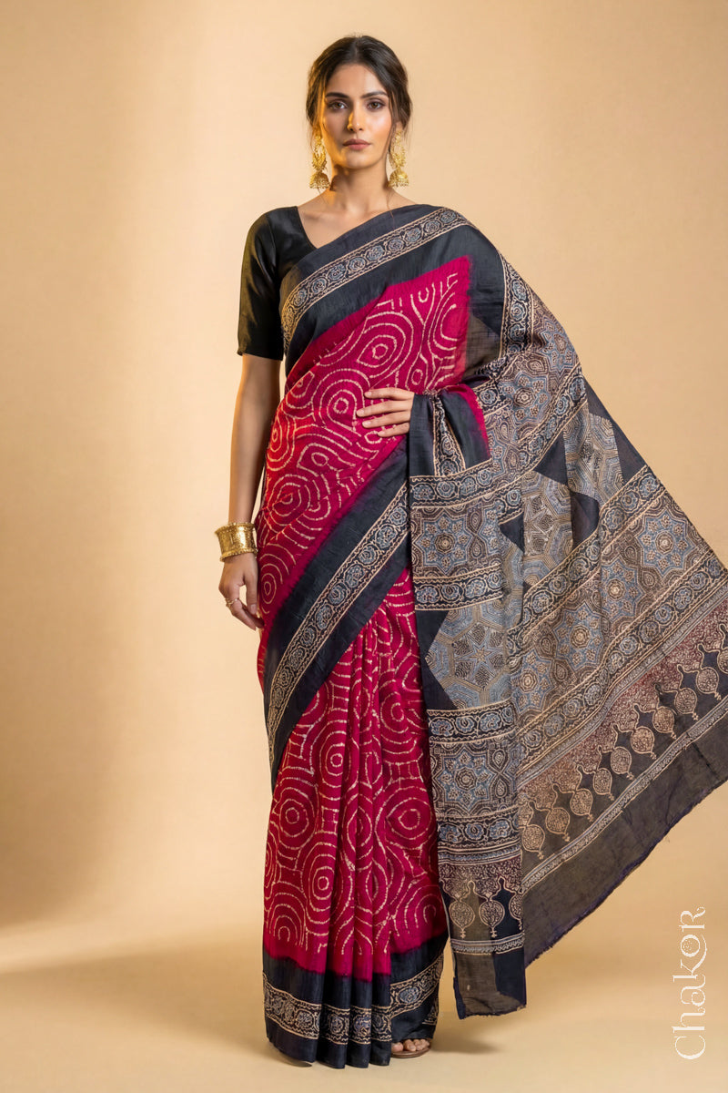 Woman wearing Red Bandhani Saree with Black Ajrakh printed border and pallu in pure gaji silk with traditional bandhej tie-dye, handcrafted in Kutch. 