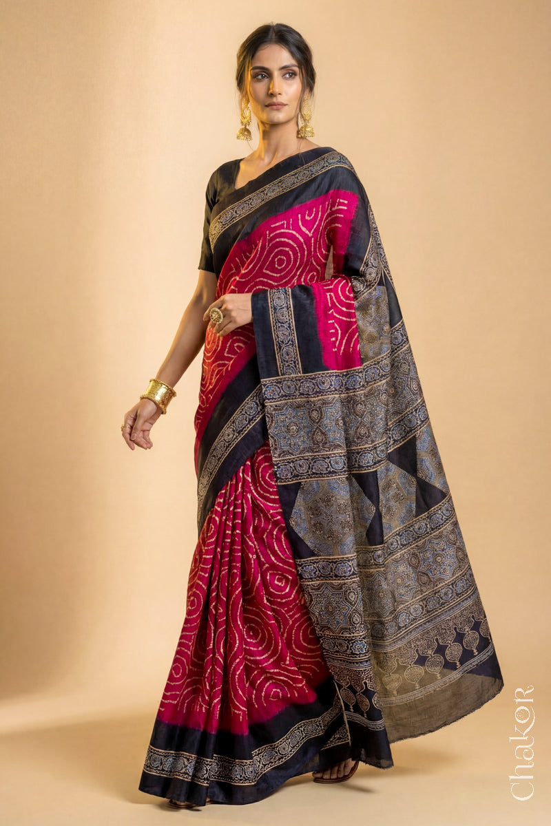 Woman wearing Red Bandhani Saree with Black Ajrakh printed border and pallu in pure gaji silk with traditional bandhej tie-dye, handcrafted in Kutch. 