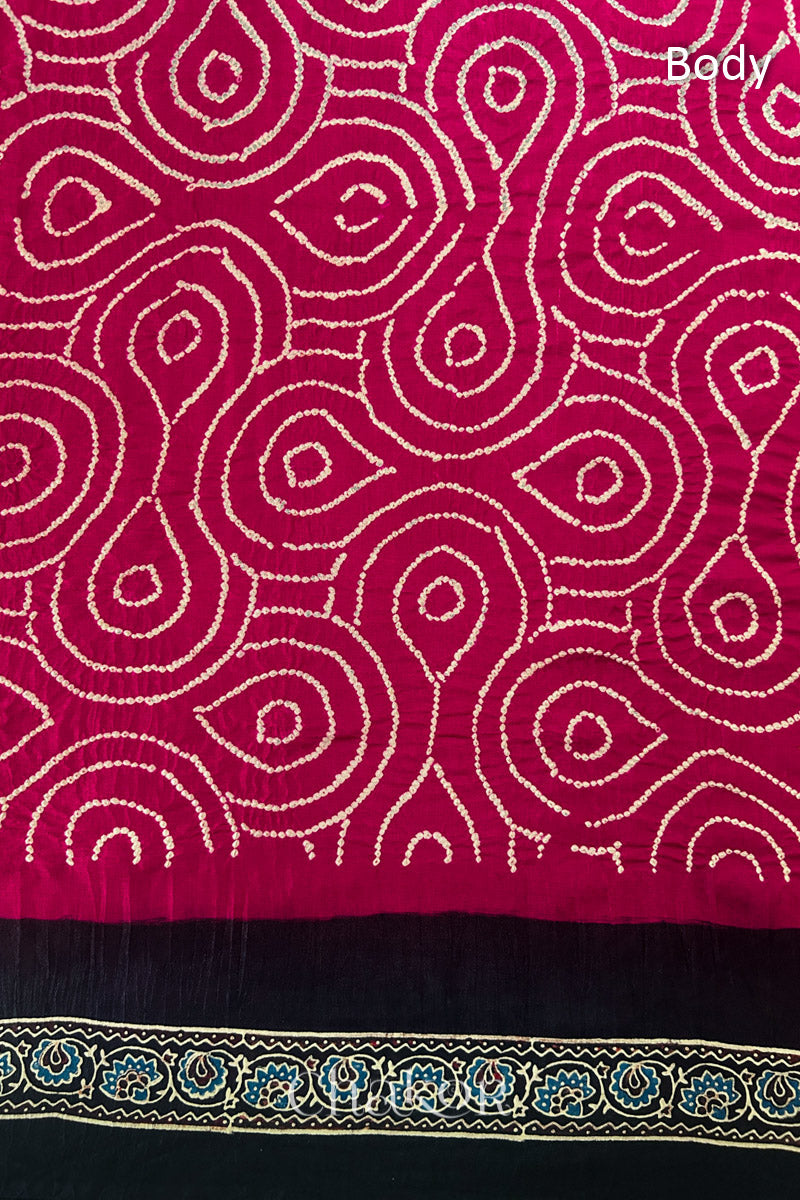 Close up of Red Bandhani Saree with Black Ajrakh printed border and pallu in pure gaji silk with traditional bandhej tie-dye, handcrafted in Kutch. 