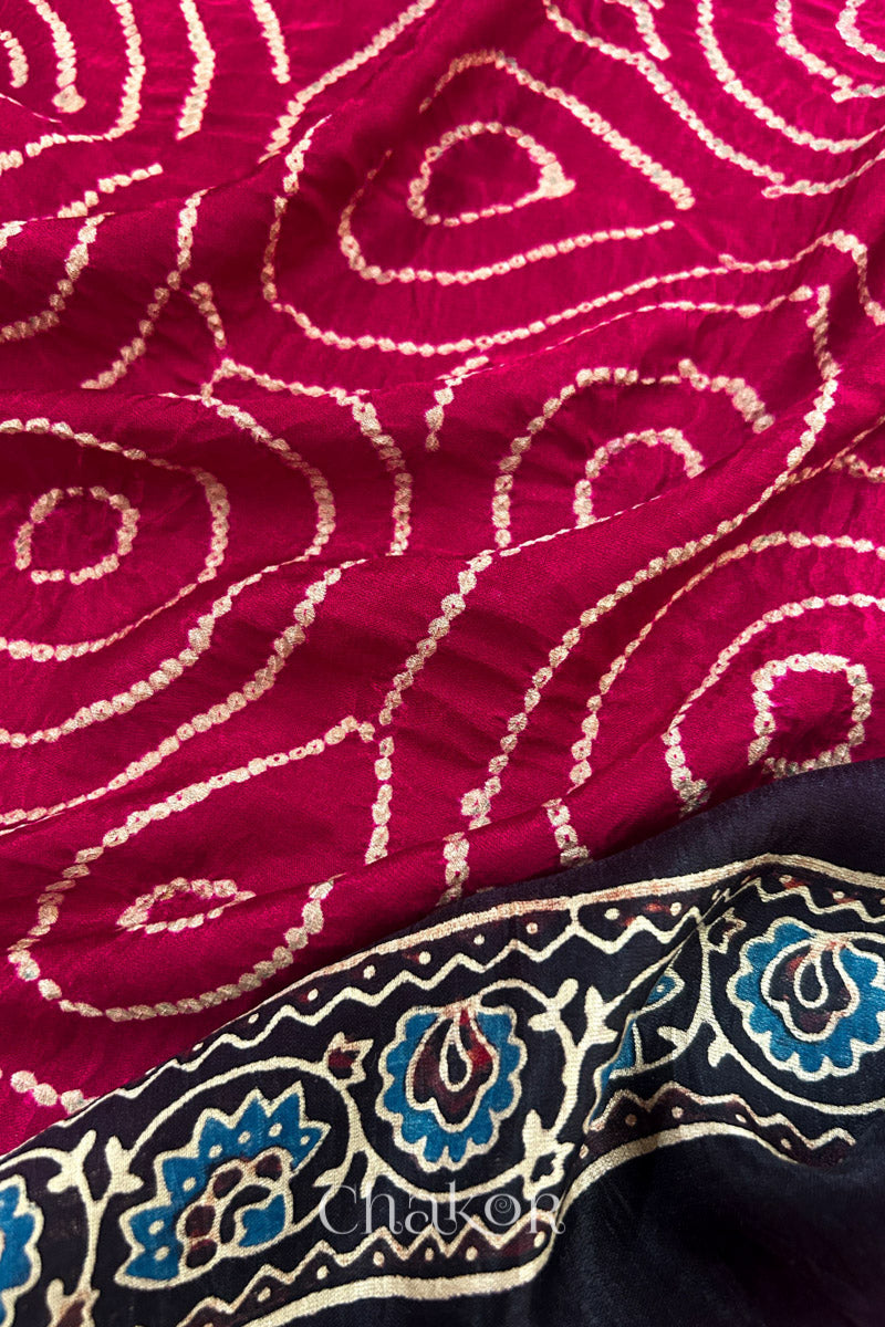Close up of Red Bandhani Saree with Black Ajrakh printed border and pallu in pure gaji silk with traditional bandhej tie-dye, handcrafted in Kutch. 