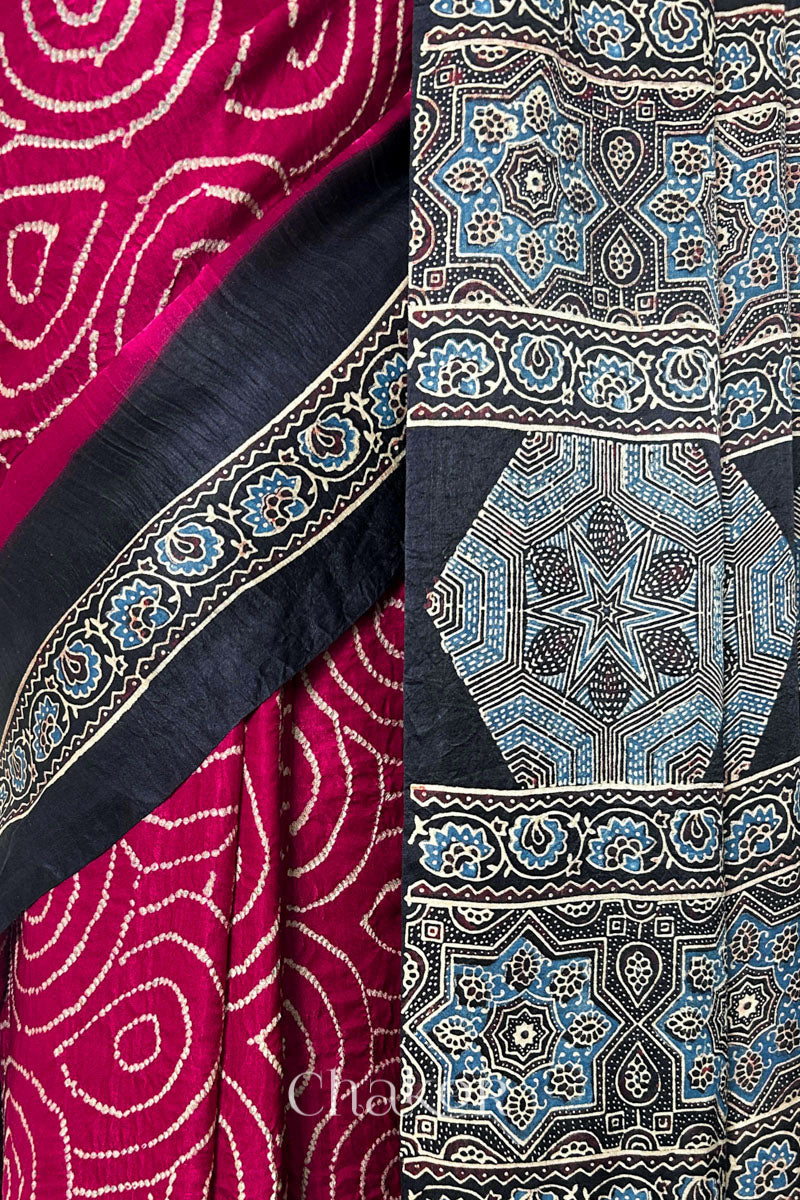Close up of Red Bandhani Saree with Black Ajrakh printed border and pallu in pure gaji silk with traditional bandhej tie-dye, handcrafted in Kutch. 