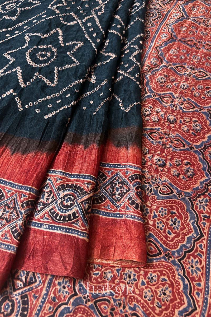 Close up of Black Bandhani Saree with Natural Red Ajrakh printed border and pallu in pure gaji silk with traditional bandhej tie-dye, handcrafted in Kutch. 