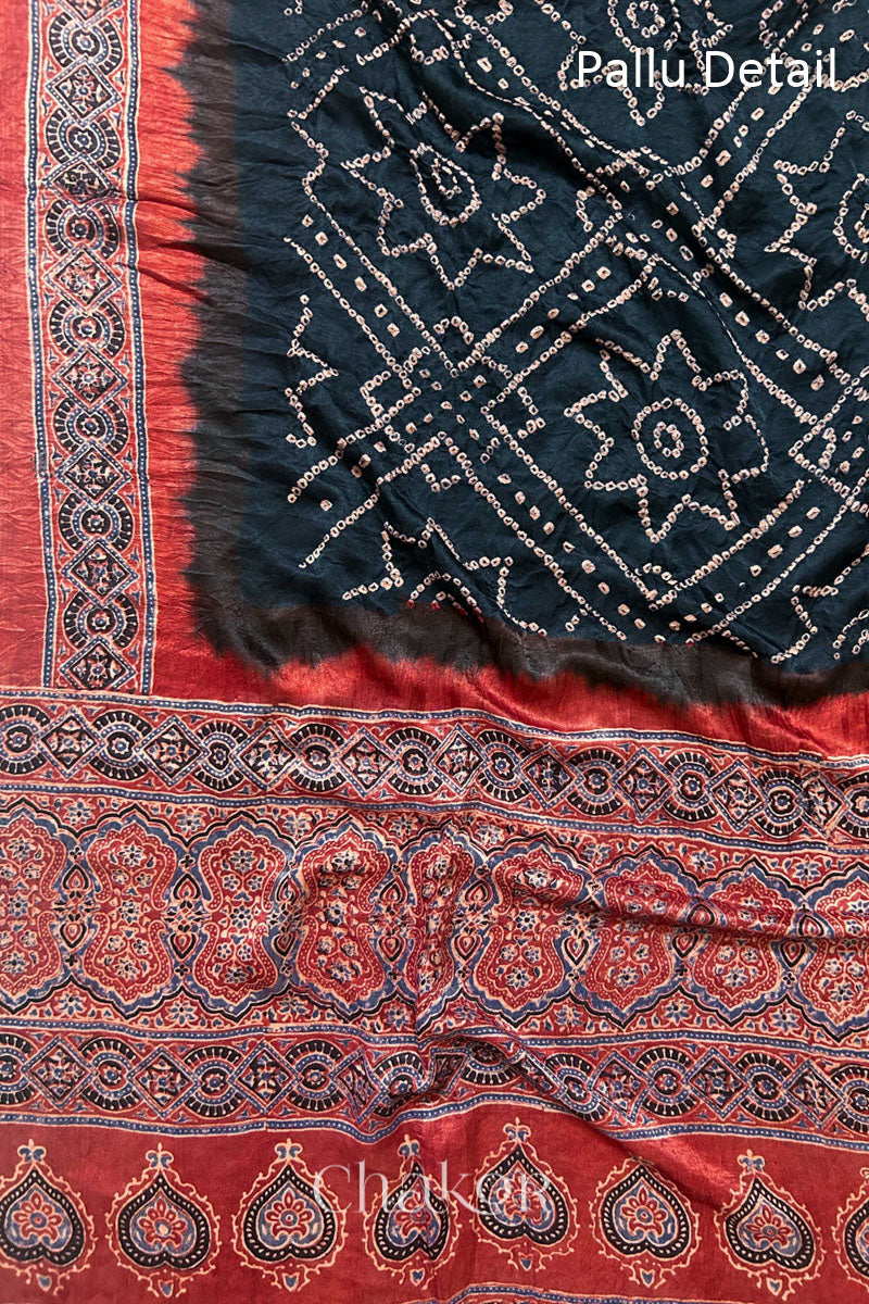 Close up of Black Bandhani Saree with Natural Red Ajrakh printed border and pallu in pure gaji silk with traditional bandhej tie-dye, handcrafted in Kutch. 