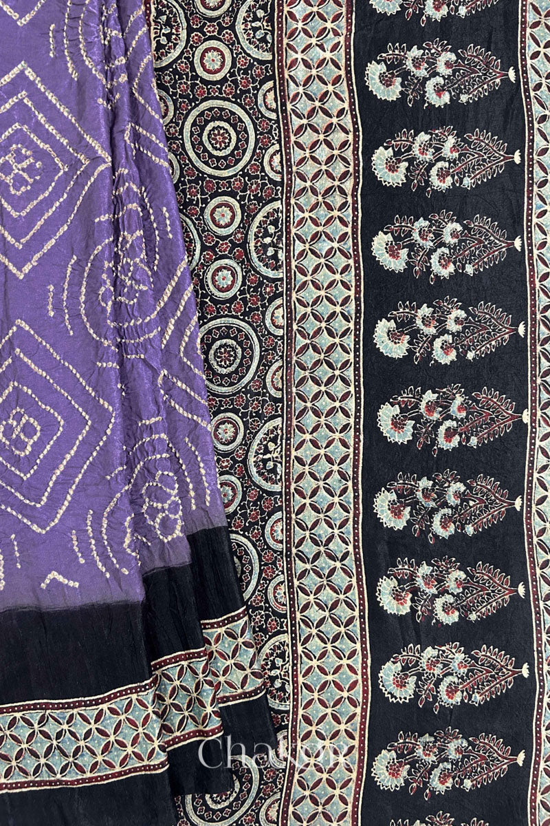 Close up of Mauve Bandhani Saree with Natural Black Ajrakh printed border and pallu in pure gaji silk with traditional bandhej tie-dye, handcrafted in Kutch. 