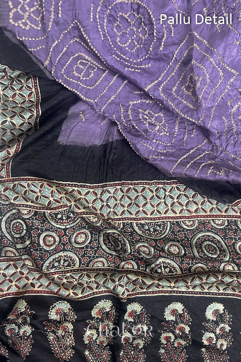 Close up of Mauve Bandhani Saree with Natural Black Ajrakh printed border and pallu in pure gaji silk with traditional bandhej tie-dye, handcrafted in Kutch. 