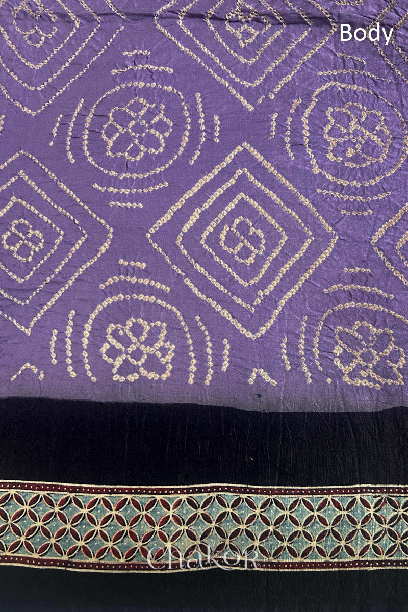 Close up of Mauve Bandhani Saree with Natural Black Ajrakh printed border and pallu in pure gaji silk with traditional bandhej tie-dye, handcrafted in Kutch. 