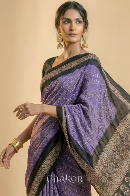 Woman wearing Mauve Bandhani Saree with Natural Black Ajrakh printed border and pallu in pure gaji silk with traditional bandhej tie-dye, handcrafted in Kutch. 