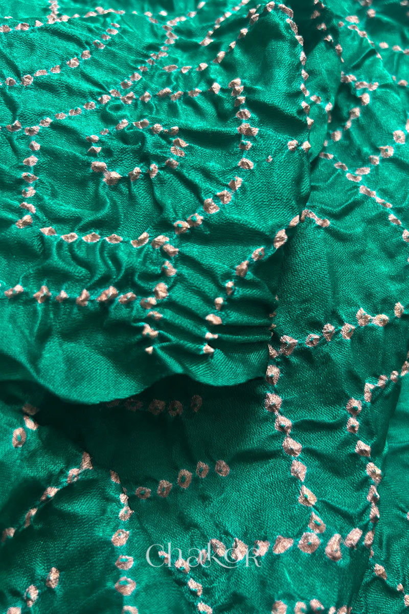 Detail view of jade green Bandhani tie-dye pattern on gaji silk dupatta fabric.