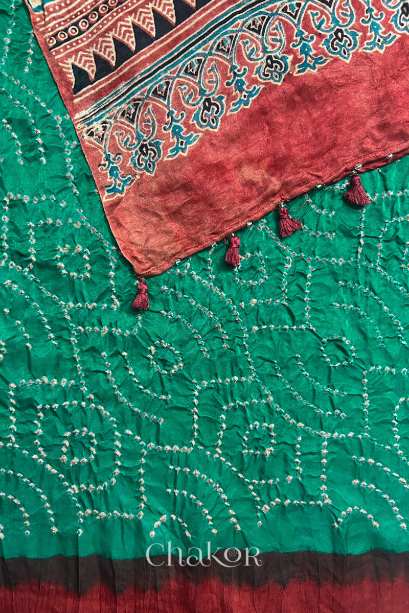Pallu detail of jade green Bandhani gaji silk dupatta with Ajrakh print and tasselled edge.