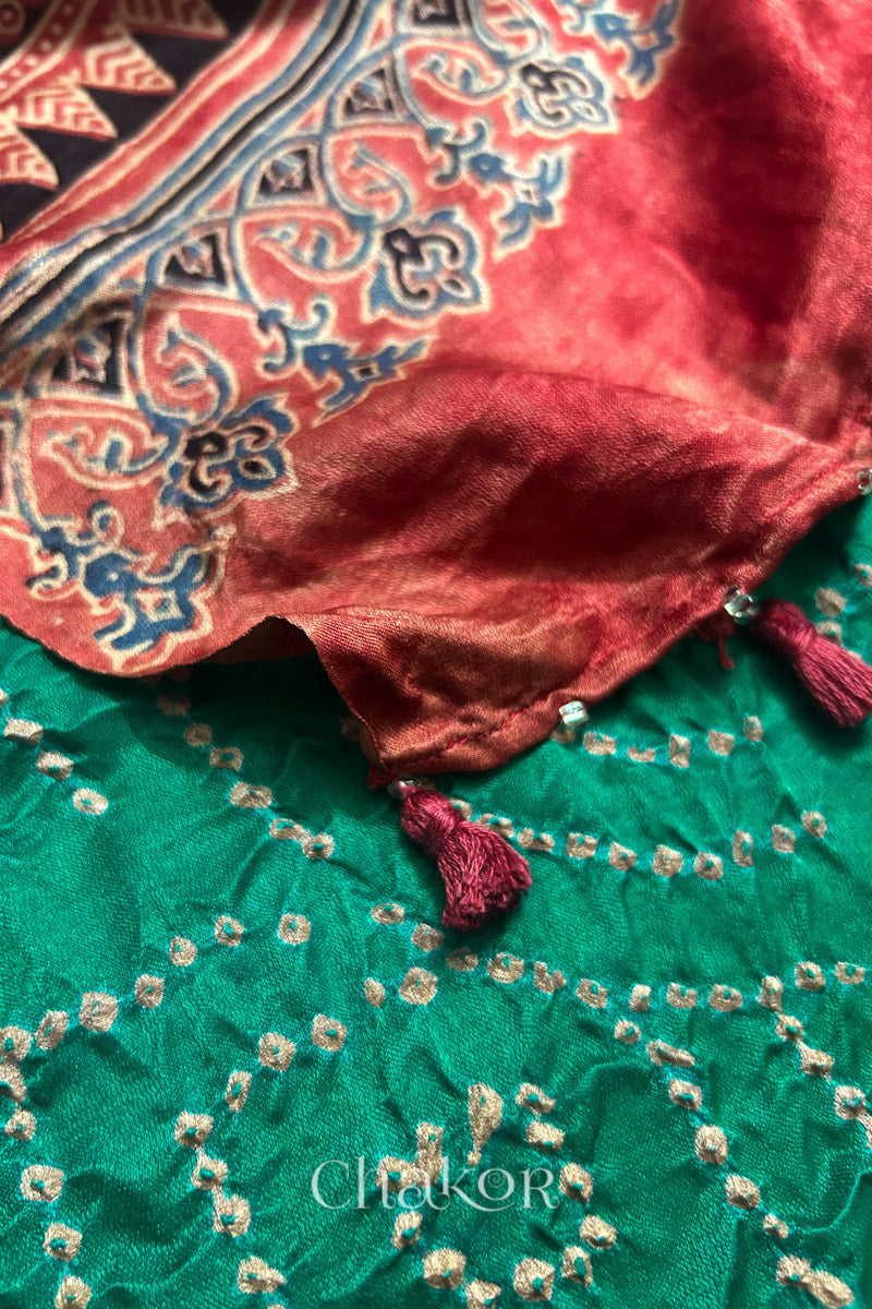 Close-up of tassels and Ajrakh pallu on jade green Bandhani gaji silk dupatta.