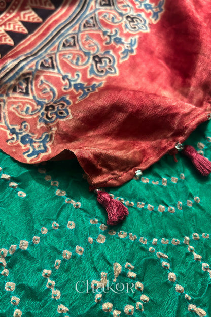 Close-up of tassels and Ajrakh pallu on jade green Bandhani gaji silk dupatta.