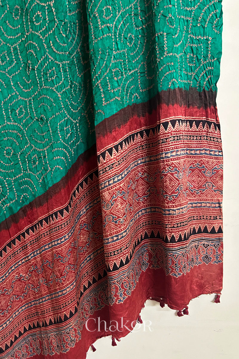 Hanging view of jade green Bandhani gaji silk dupatta highlighting Ajrakh pallu and border.