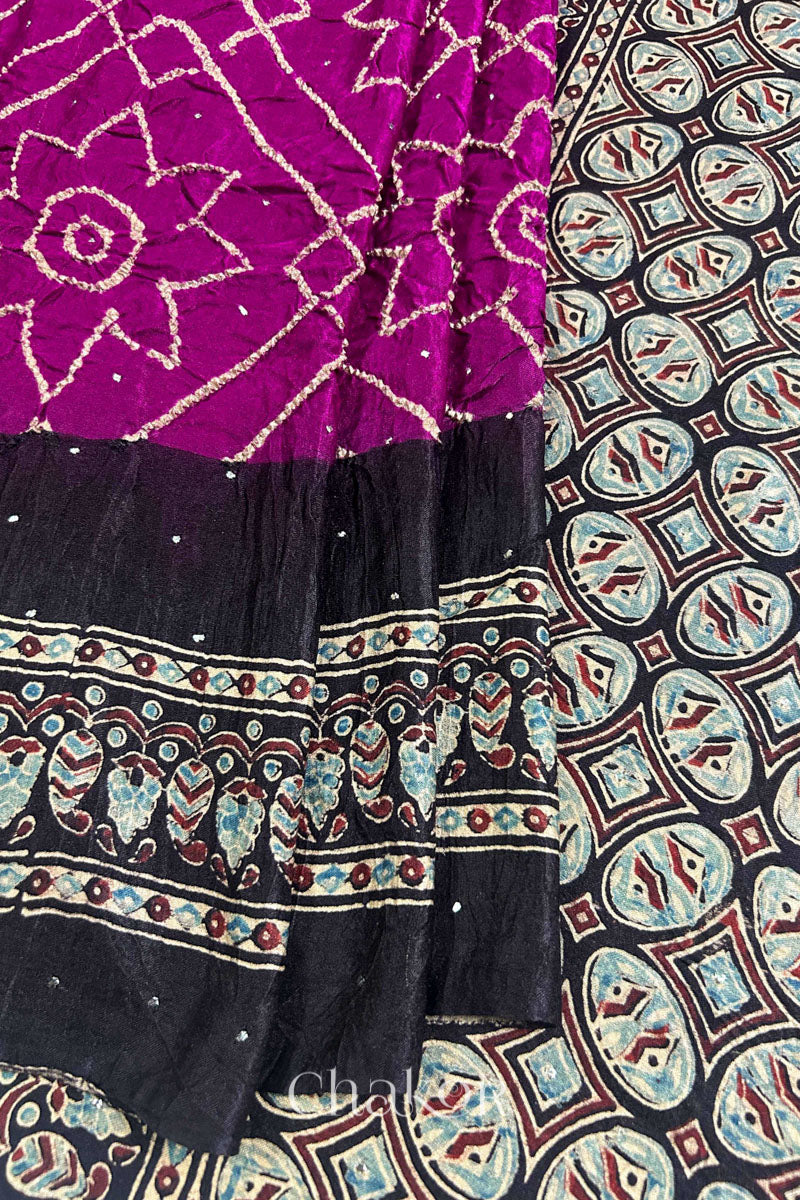 Close up of Magenta Bandhani Saree with Natural Black Ajrakh printed border and pallu in pure gaji silk with traditional bandhej tie-dye & mukaish embroidery, handcrafted in Kutch. 