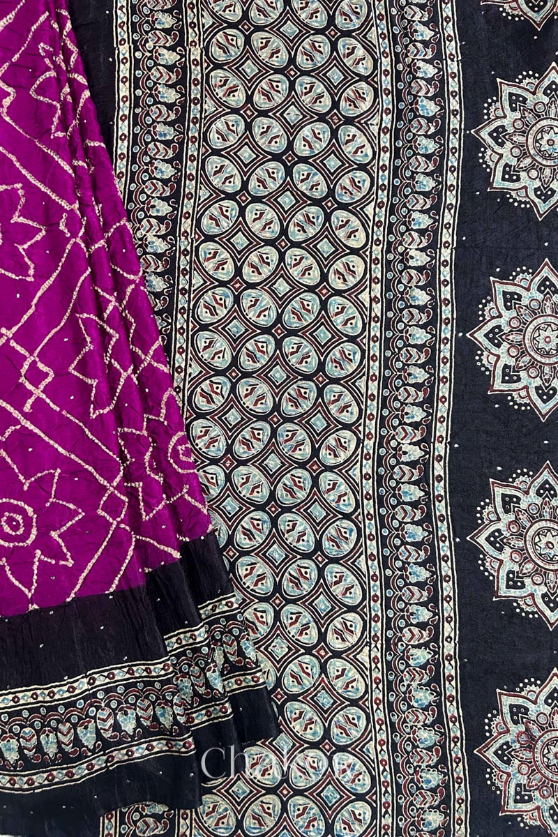 Close up of Magenta Bandhani Saree with Natural Black Ajrakh printed border and pallu in pure gaji silk with traditional bandhej tie-dye & mukaish embroidery, handcrafted in Kutch. 