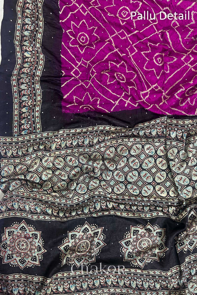 Close up of Magenta Bandhani Saree with Natural Black Ajrakh printed border and pallu in pure gaji silk with traditional bandhej tie-dye & mukaish embroidery, handcrafted in Kutch. 