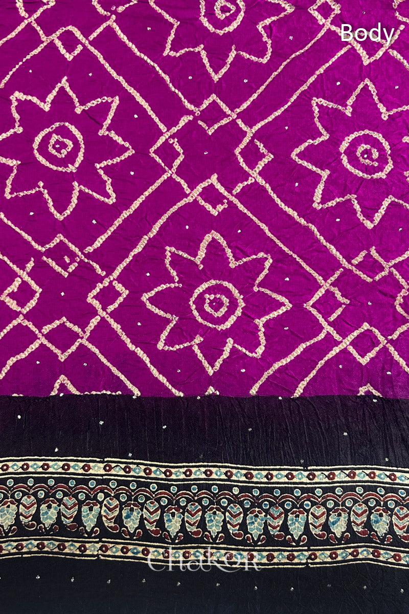 Close up of Magenta Bandhani Saree with Natural Black Ajrakh printed border and pallu in pure gaji silk with traditional bandhej tie-dye & mukaish embroidery, handcrafted in Kutch. 