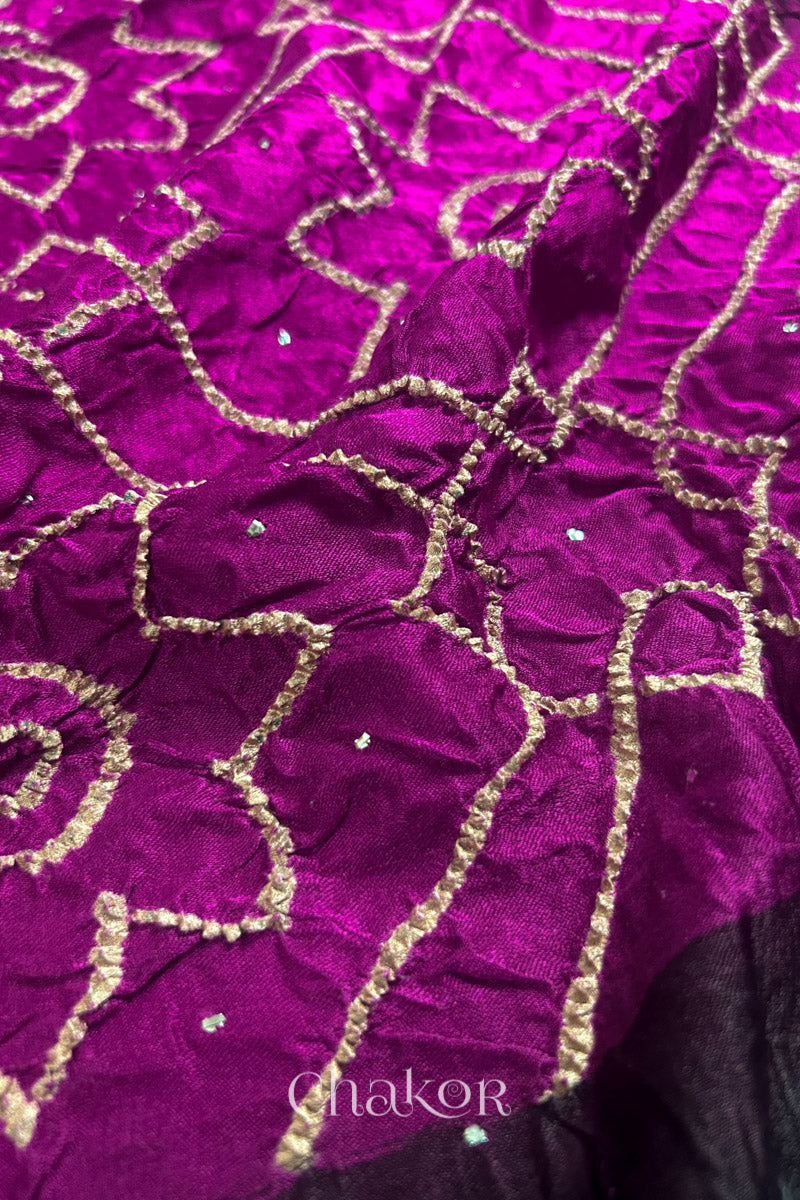Close up of Magenta Bandhani Saree with Natural Black Ajrakh printed border and pallu in pure gaji silk with traditional bandhej tie-dye & mukaish embroidery, handcrafted in Kutch. 
