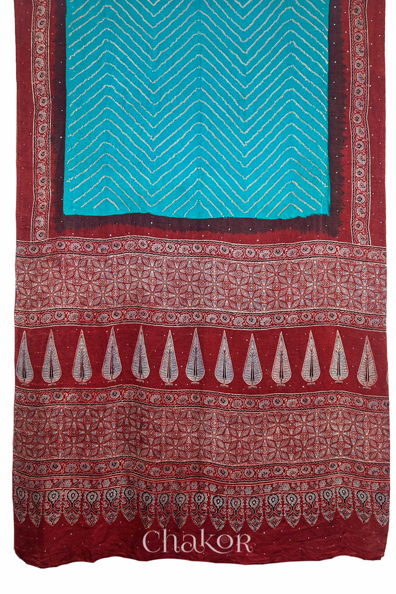 Full view of Peacock Blue Bandhani Saree with Natural Red Ajrakh printed border and pallu in pure gaji silk with traditional bandhej tie-dye & mukaish embroidery, handcrafted in Kutch. 