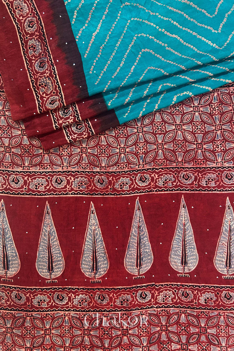 Close up of Peacock Blue Bandhani Saree with Natural Red Ajrakh printed border and pallu in pure gaji silk with traditional bandhej tie-dye & mukaish embroidery, handcrafted in Kutch. 