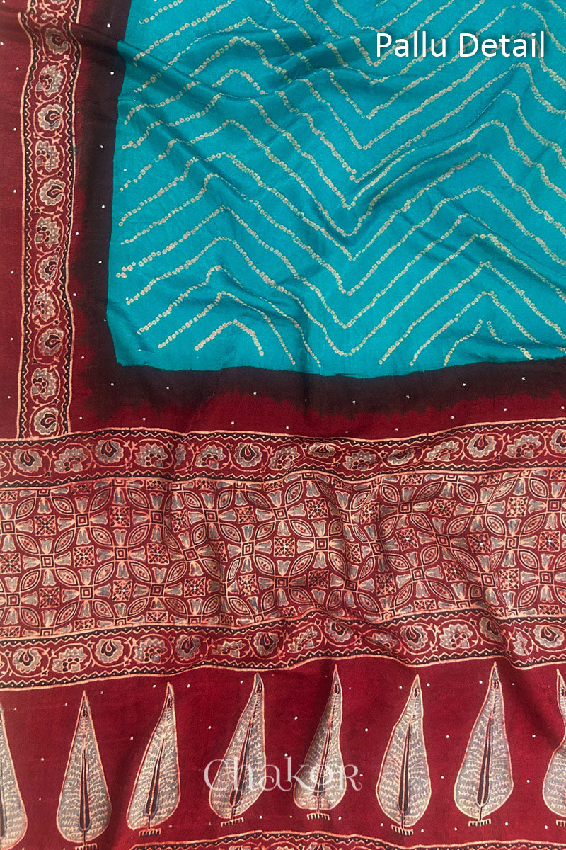 Close up of Peacock Blue Bandhani Saree with Natural Red Ajrakh printed border and pallu in pure gaji silk with traditional bandhej tie-dye & mukaish embroidery, handcrafted in Kutch. 