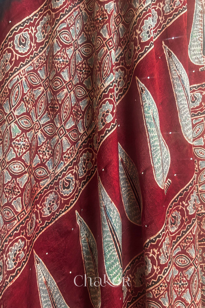 Close up of Peacock Blue Bandhani Saree with Natural Red Ajrakh printed border and pallu in pure gaji silk with traditional bandhej tie-dye & mukaish embroidery, handcrafted in Kutch. 