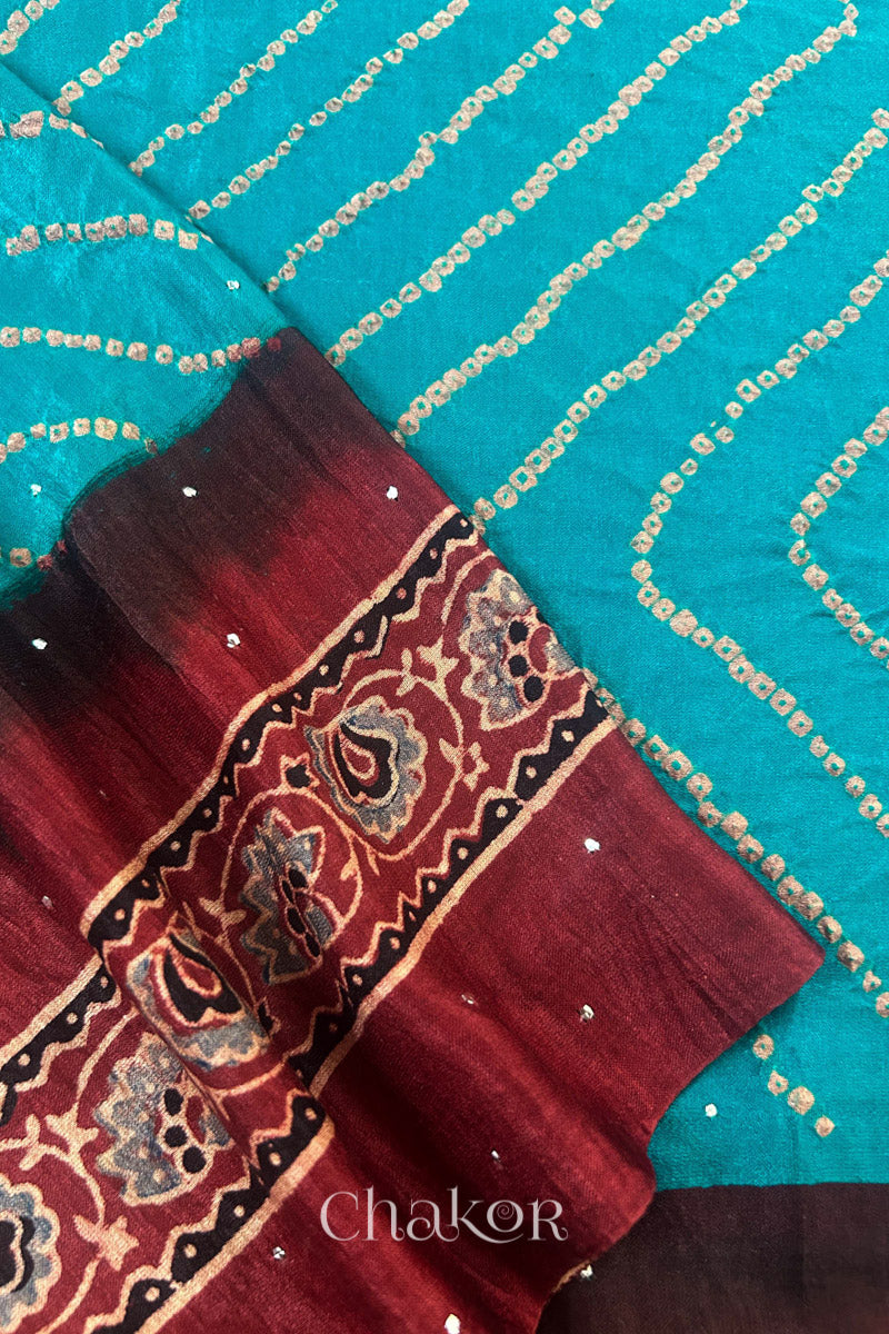Close up of Peacock Blue Bandhani Saree with Natural Red Ajrakh printed border and pallu in pure gaji silk with traditional bandhej tie-dye & mukaish embroidery, handcrafted in Kutch. 