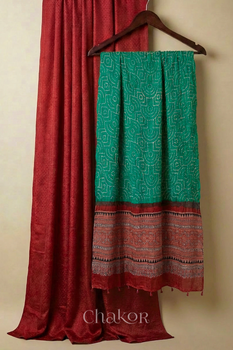 Brick red mashru kurta set fabric paired with jade green bandhani gaji silk dupatta featuring ajrakh printed pallu.