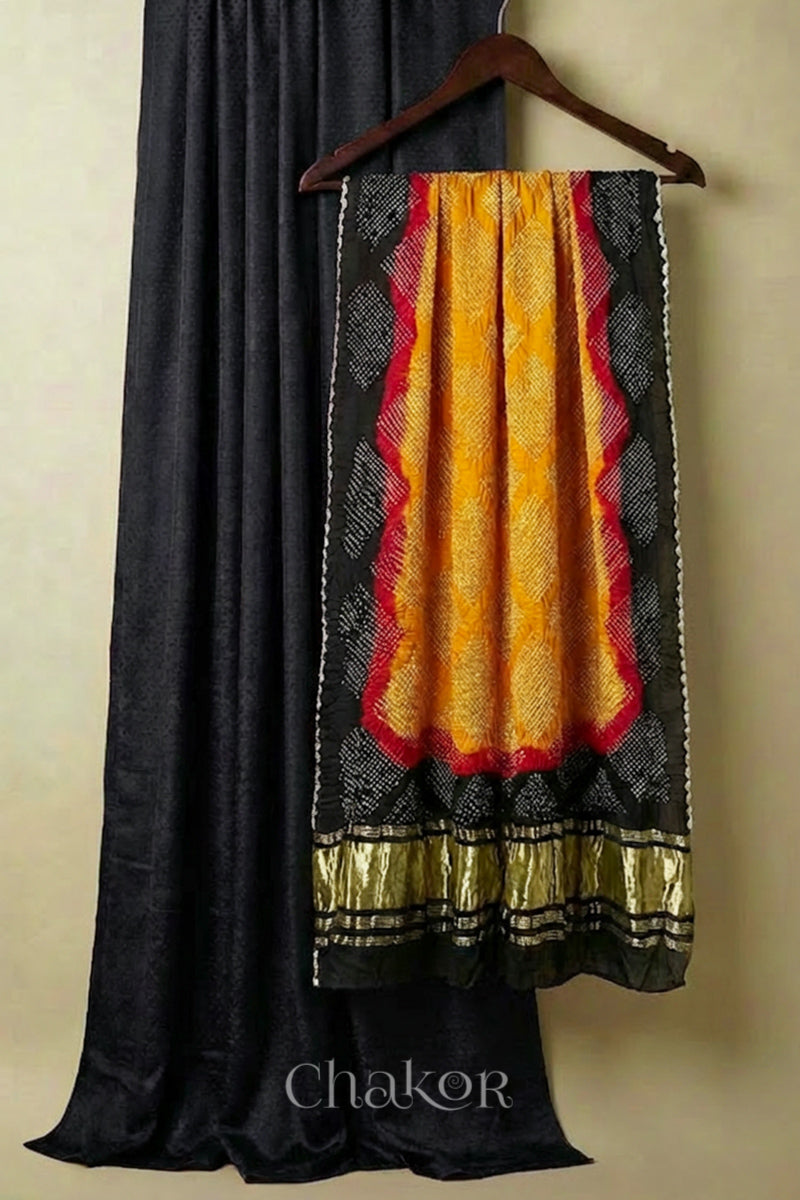 Black mashru kurta set fabric with mustard yellow bandhani gaji silk dupatta featuring black border & ,lagdi patta' pallu.
