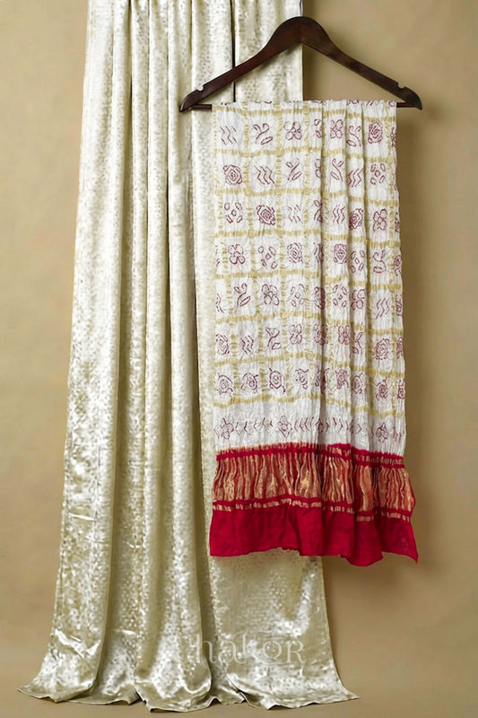 Off white mashru silk kurta set fabric with white & red bandhani gharchola gaji silk dupatta featuring red zari pallu.