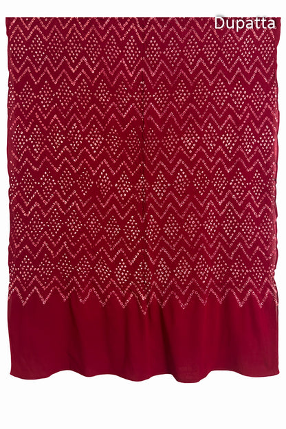 Full view of the red dupatta from the kurta set with intricate zigzag bandhani patterns, with Chakor logo. The design showcases artisanal craftsmanship.