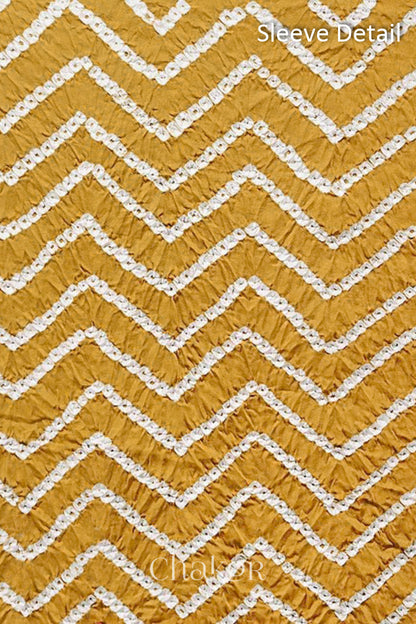 Close-up of bandhani sleeve detail featuring chevron tie-dye design, with Chakor brand logo.
