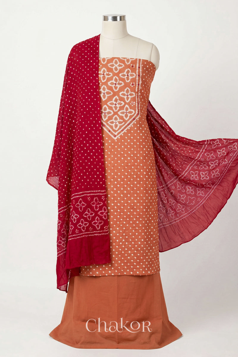Brick Orange Kutch Bandhani cotton unstitched suit set, mirror work kurta with Red mulmul cotton dupatta.
