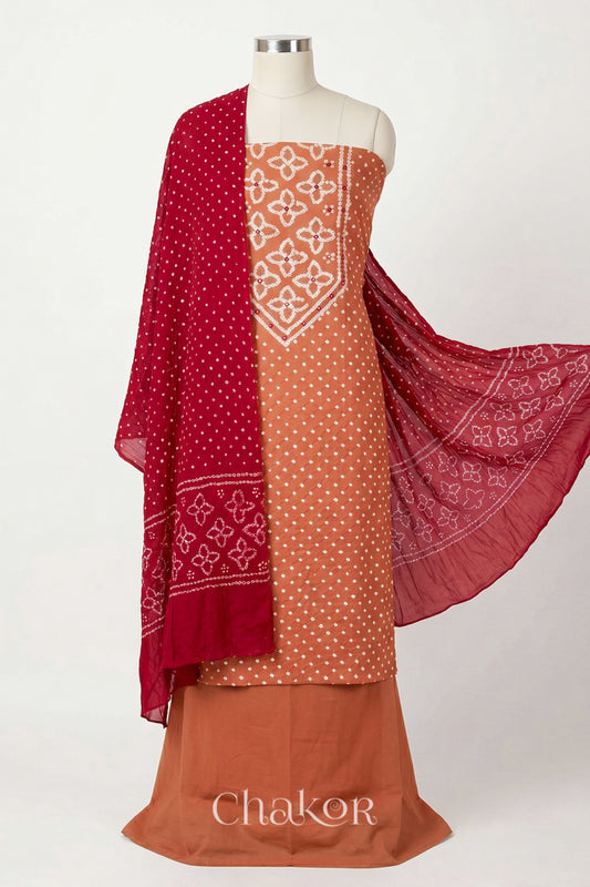Brick Orange Kutch Bandhani cotton unstitched suit set, mirror work kurta with Red mulmul cotton dupatta.

