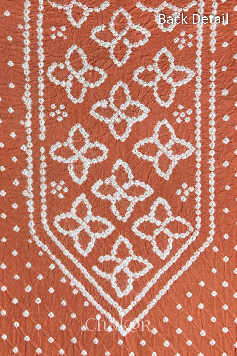 Back yoke detail featuring traditional Bandhani floral motifs on Brick Orange cotton fabric.
