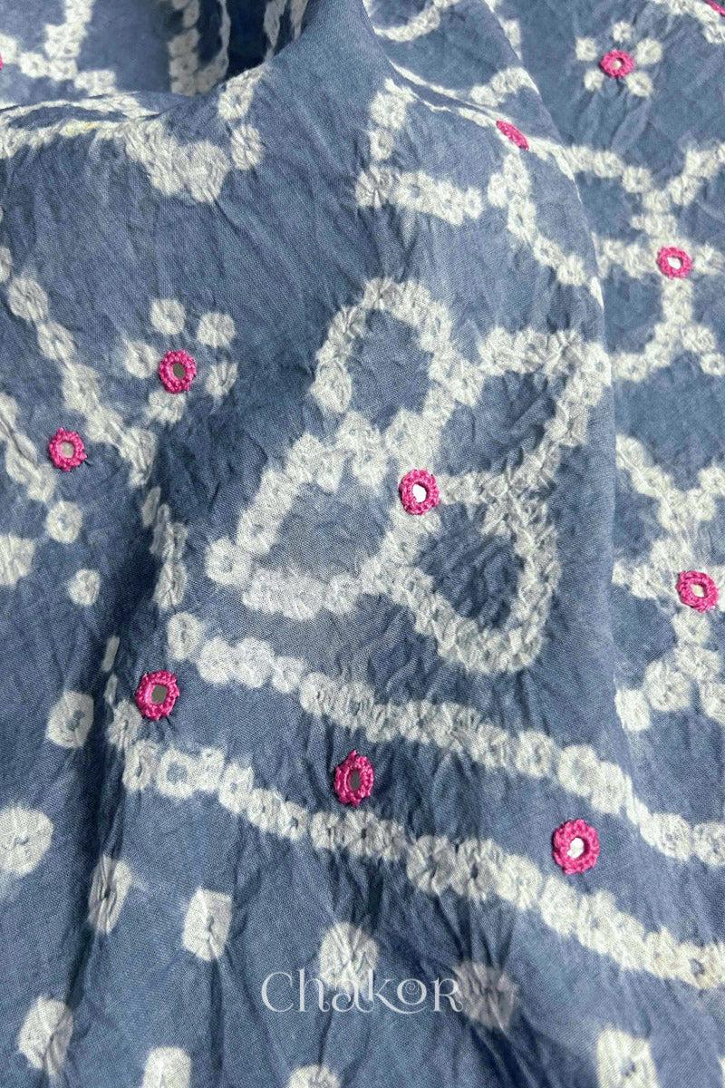 Hand tied Bandhani floral motif with colourful mirror embroidery on Grey cotton fabric.
