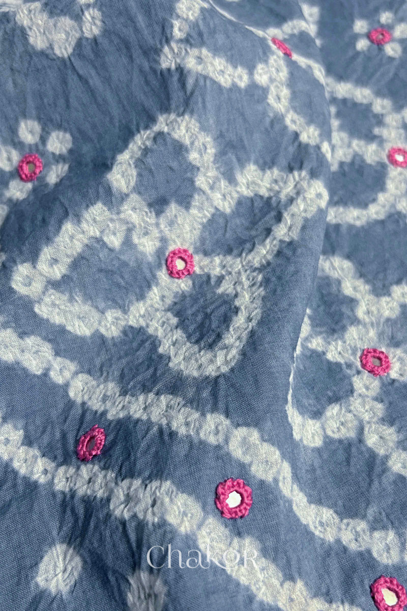 Close-up of Bandhani floral pattern accented with hand embroidery Grey mirror work.
