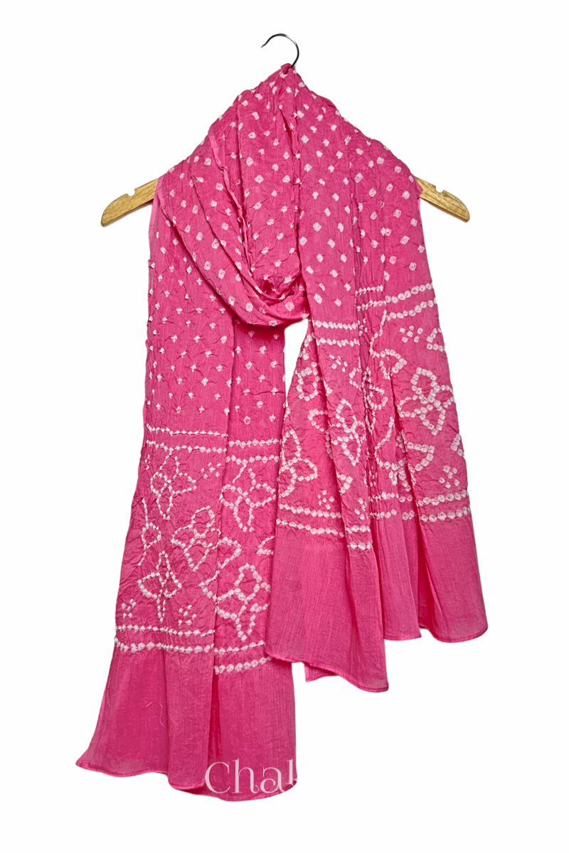 Red mercerised mulmul cotton dupatta with Bandhani floral pallu design draped on hanger.
