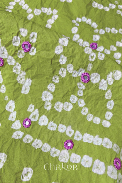 Close-up of Bandhani floral pattern accented with hand embroidery Green mirror work.
