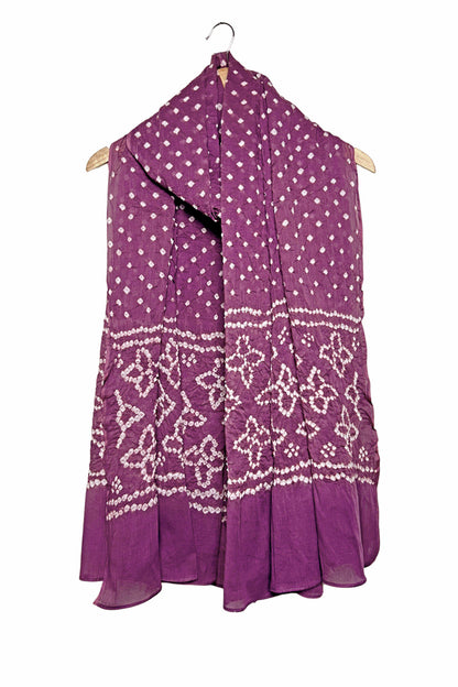 Mauve mercerised mulmul cotton dupatta with Bandhani floral pallu design draped on hanger.
