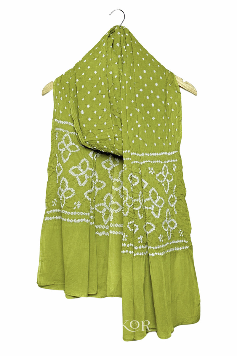 Lime Green mercerised mulmul cotton dupatta with Bandhani floral pallu design draped on hanger.
