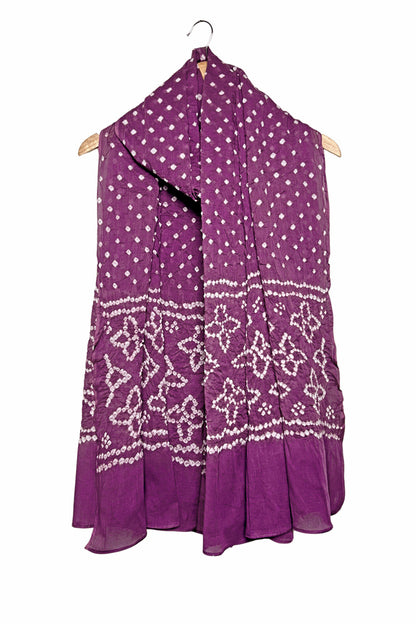 Mauve mercerised mulmul cotton dupatta with Bandhani floral pallu design draped on hanger.
